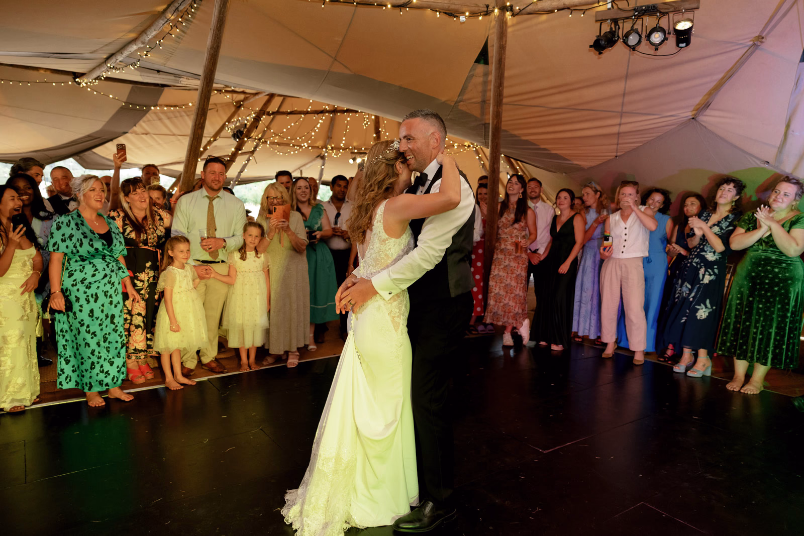 Guests slow dancing tipi at a family farm wedding in Taunton