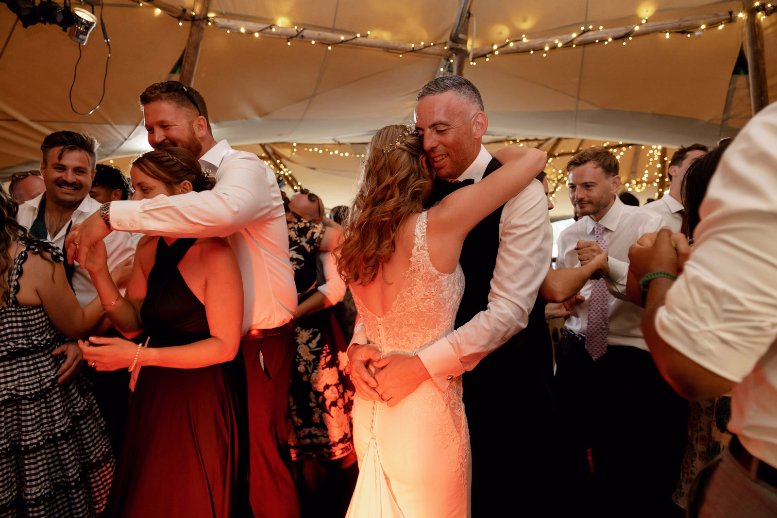 Guests hugging dancefloor tipi at a countryside wedding in Taunton, Somerset