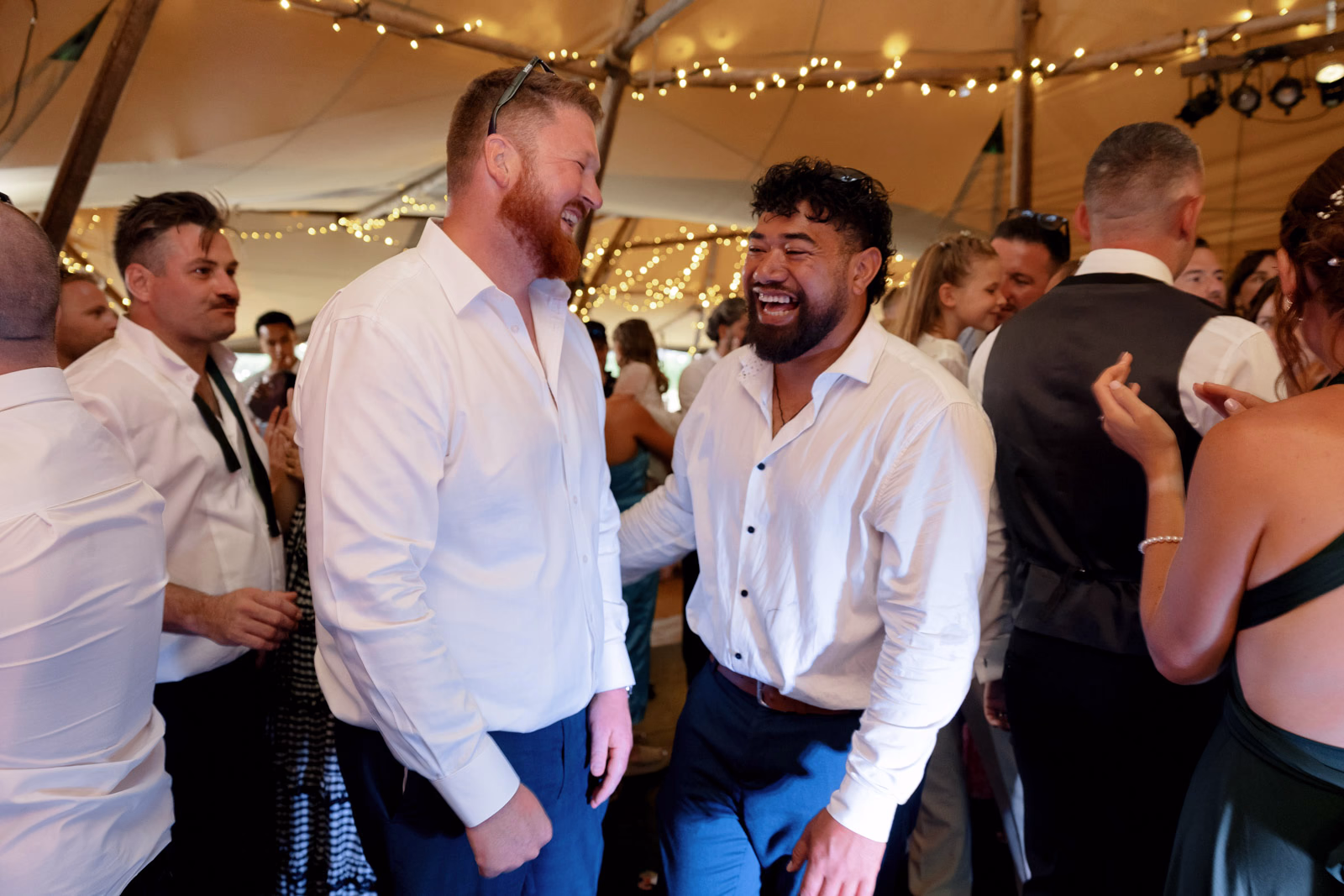 Guests laughing and dancing at a family farm wedding in Taunton