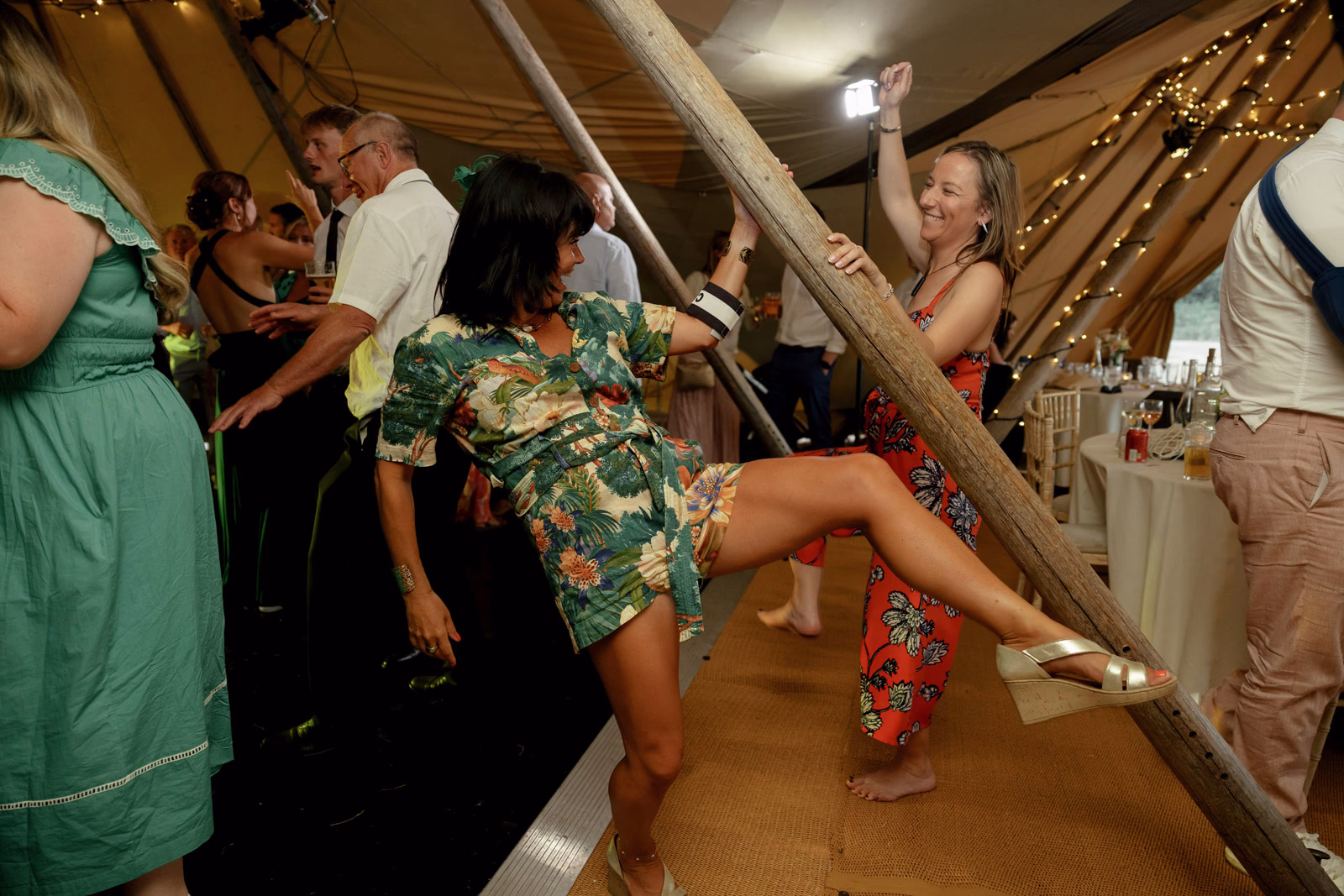 Guest dancing high kick at a family farm wedding in Taunton