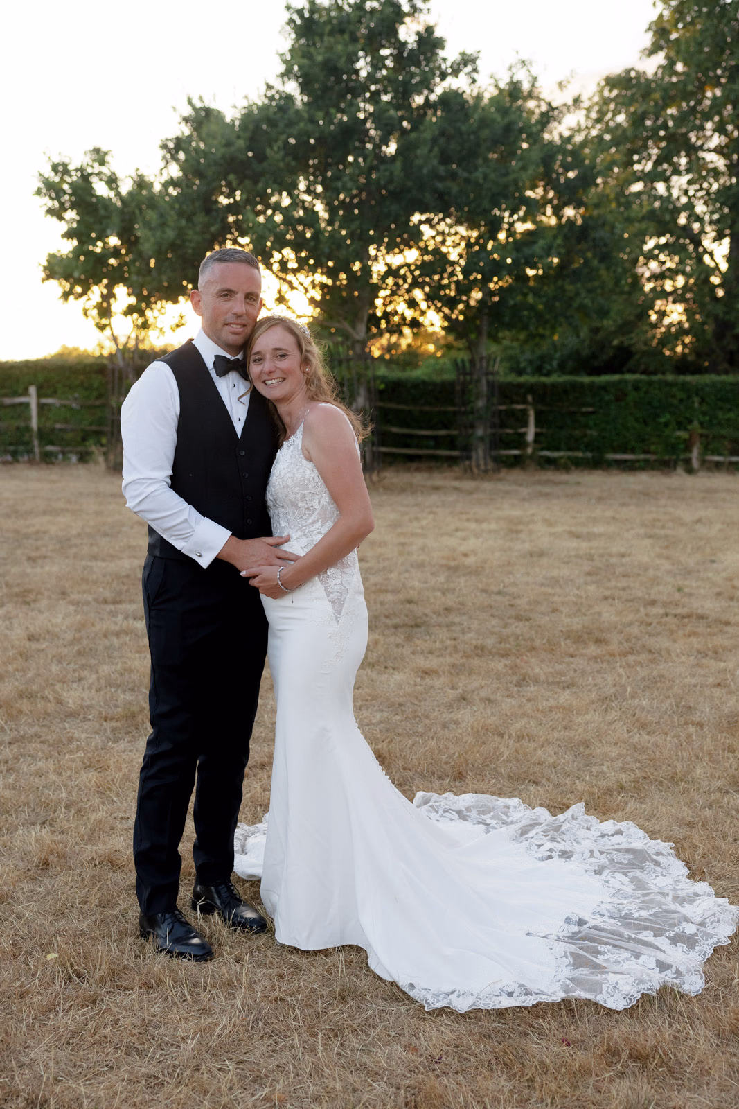 Bride and groom full-length sunset portrait at a Taunton farm wedding, photographed by Tanya Bogdan Photography