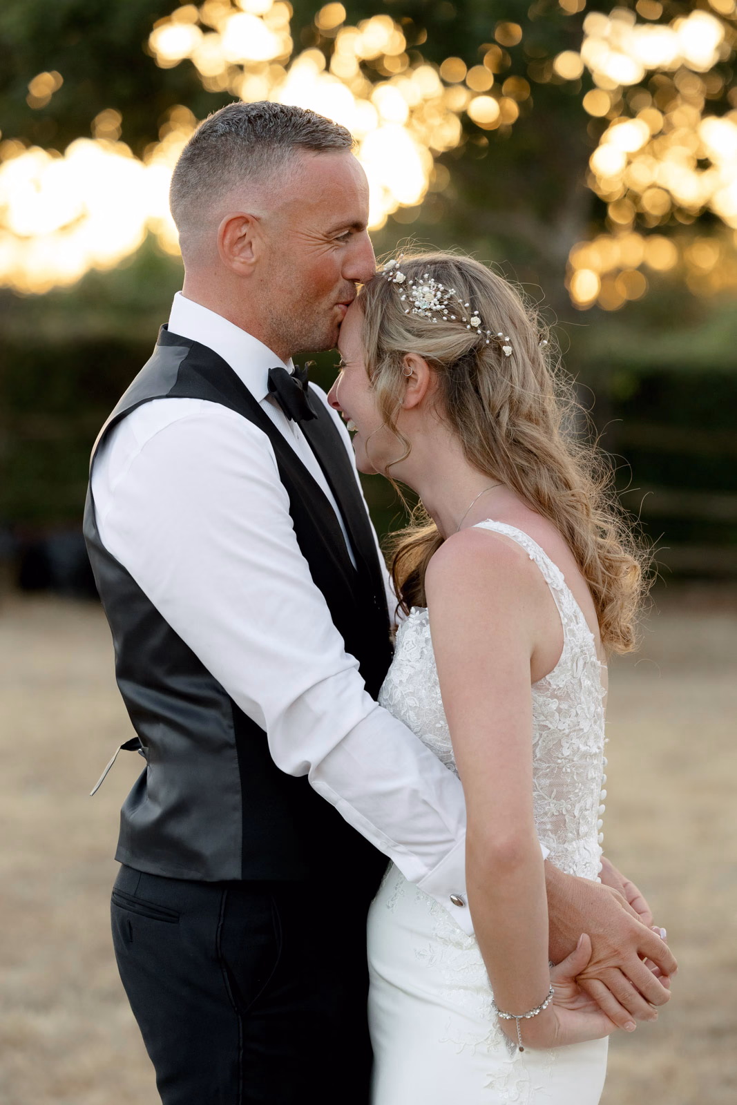 Groom kissing bride forehead sunset at a countryside wedding in Taunton, Somerset