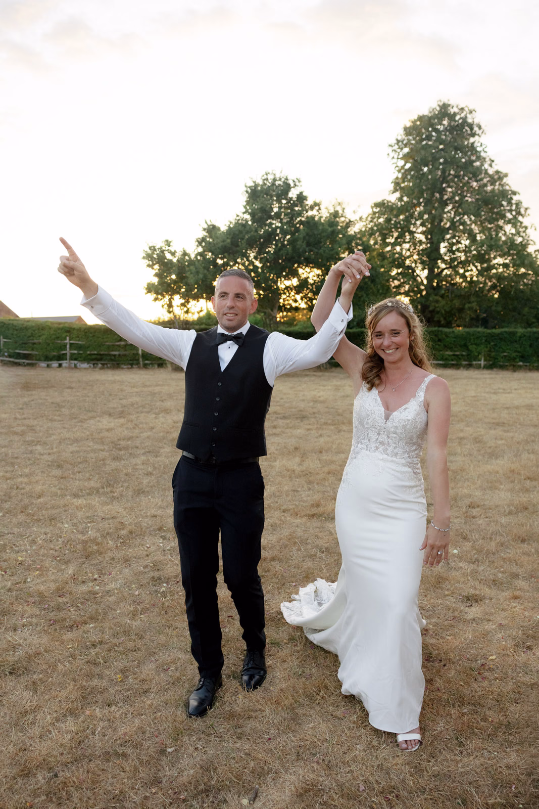 Bride and groom celebrating sunset at a family farm wedding in Taunton