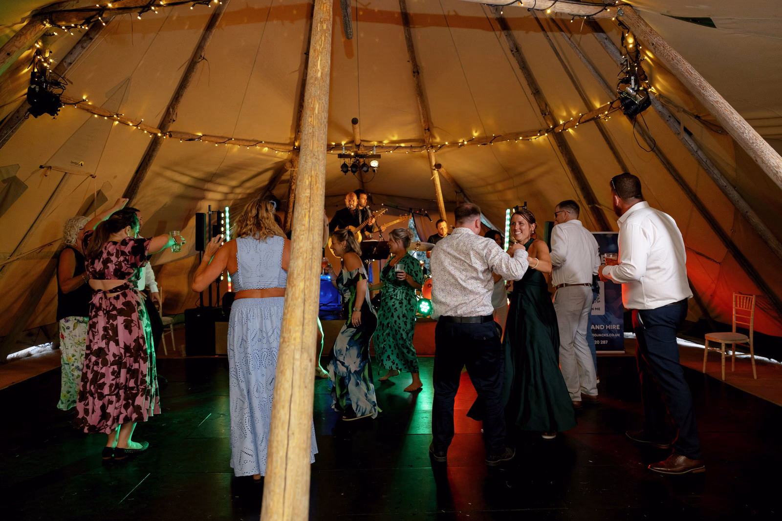 Guests dancing tipi evening party at a family farm wedding in Taunton