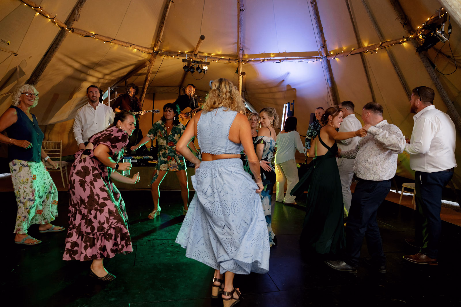 Guests dancing wedding party tipi at a countryside wedding in Taunton, Somerset