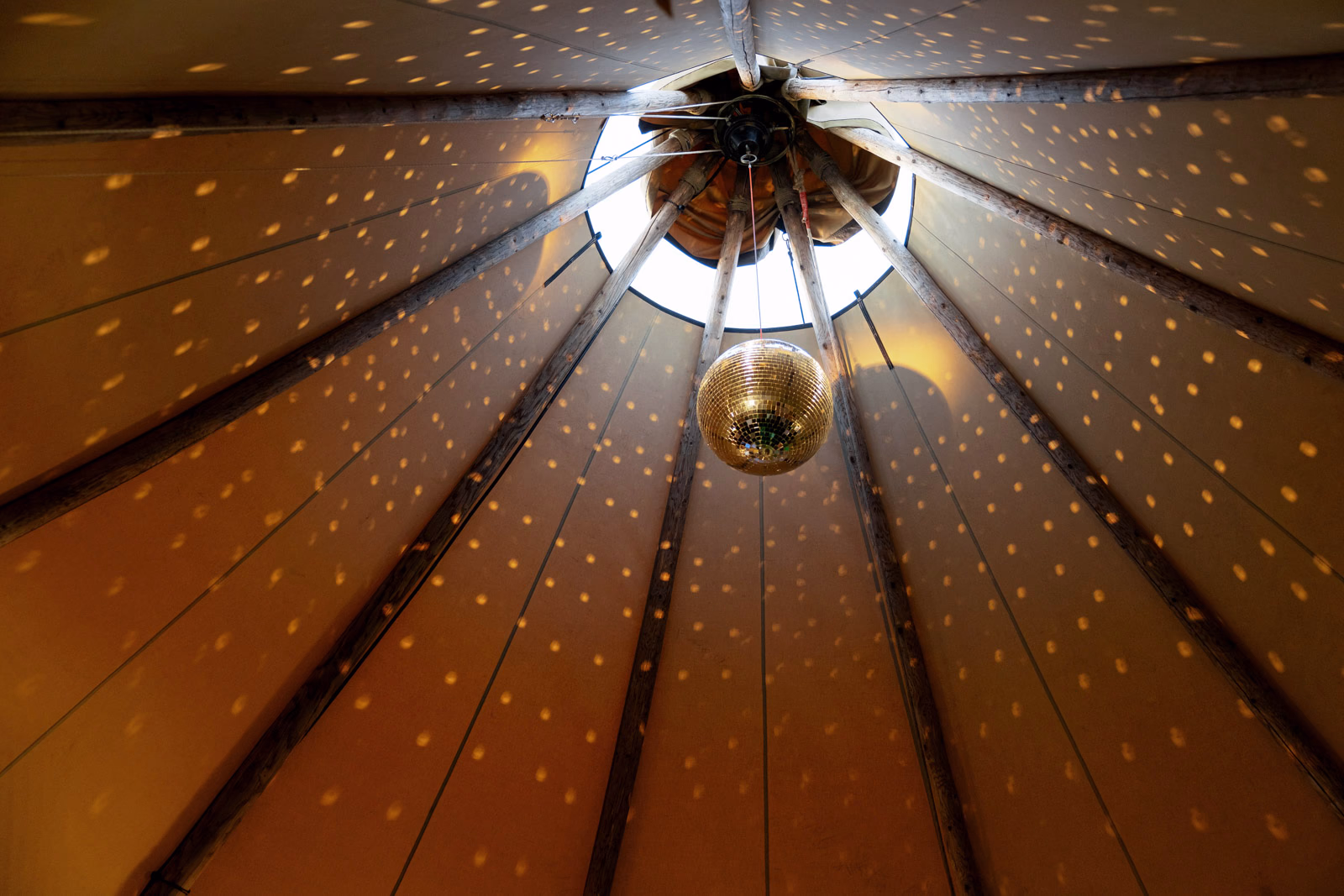Tipi ceiling disco ball at a Taunton farm wedding, photographed by Tanya Bogdan Photography