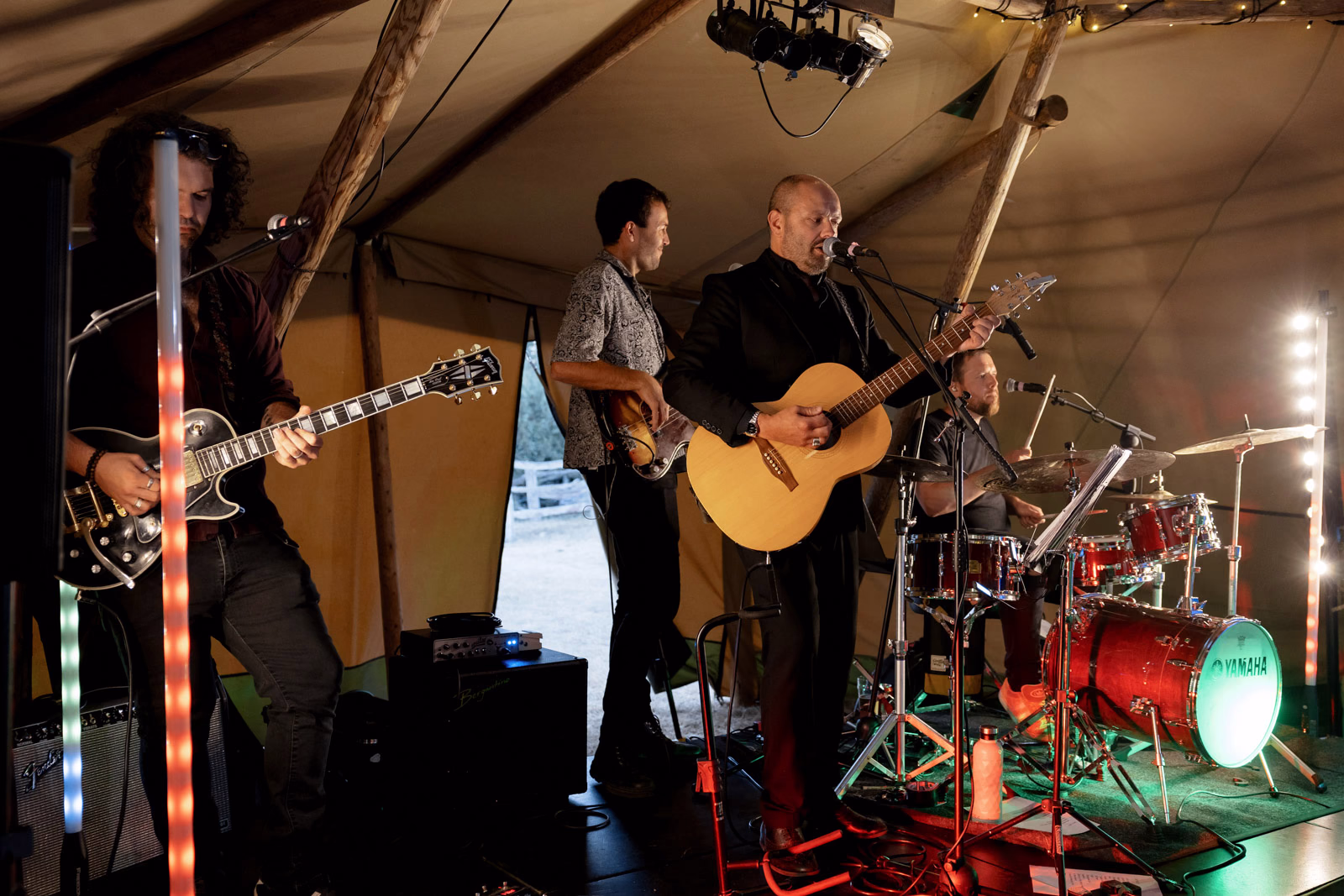 Live band guitar drums tipi at a family farm wedding in Taunton